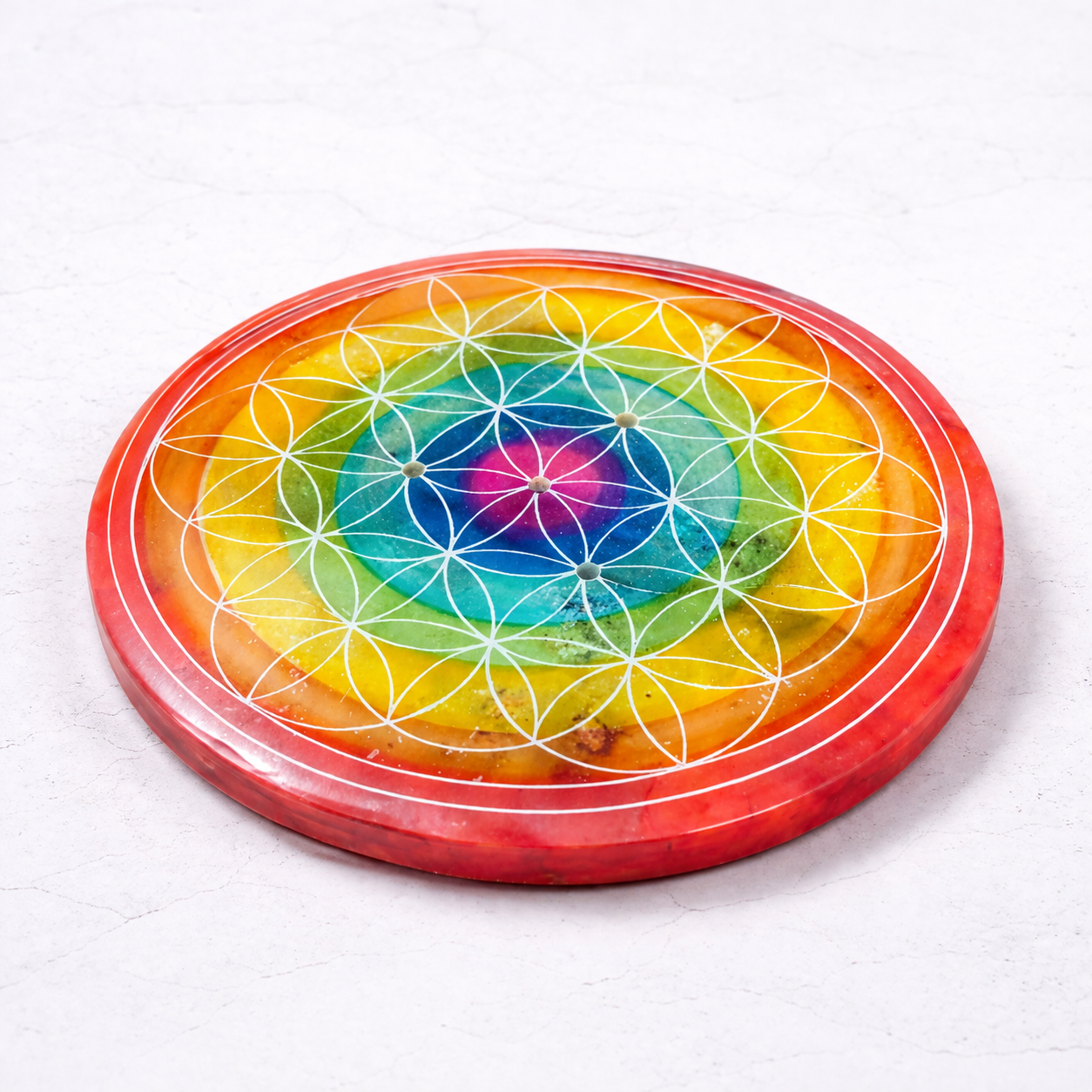 Colorful circular object with geometric design on a white background