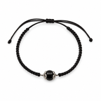 Black macrame bracelet with a central onyx bead on a white background