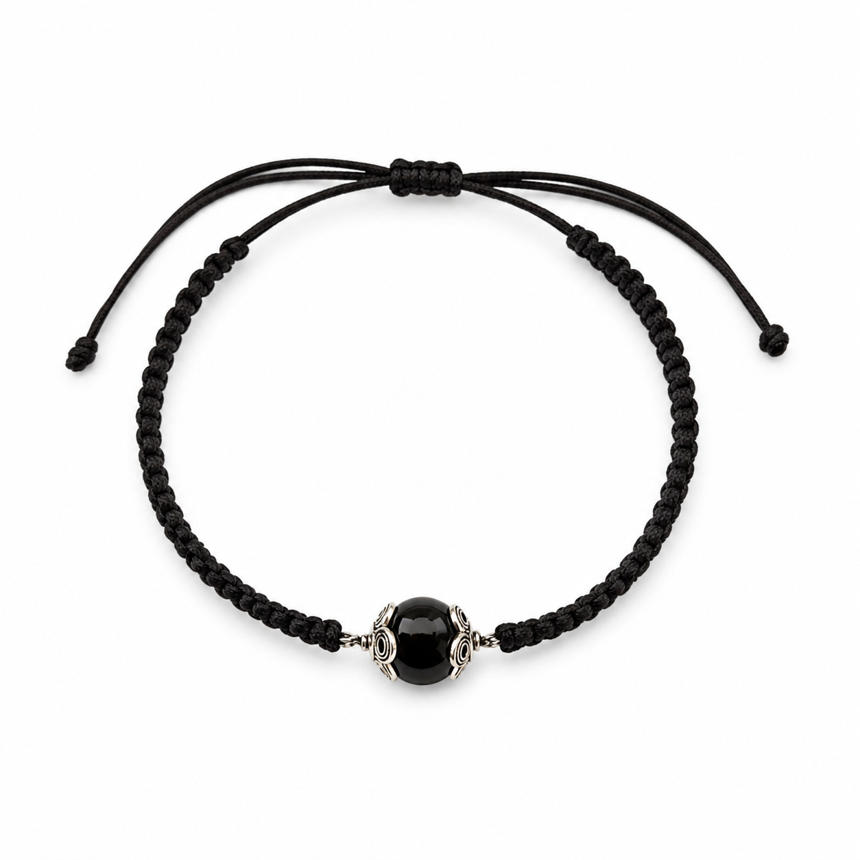 Black macrame bracelet with a central onyx bead on a white background